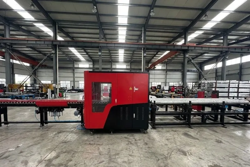 Heineda C6 cutting machine side view with material conveyor system in factory environment